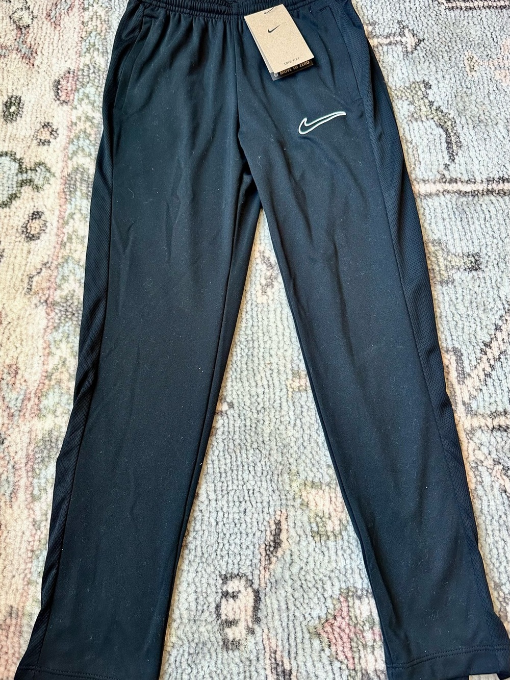 Nike boy’s athletic track pants with side zip on hem, size M